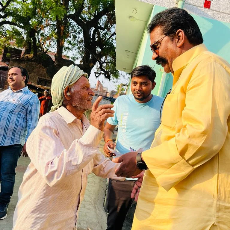 Ajay Munshi greeting elders in Mallawan — Bajiganj ward, 1995